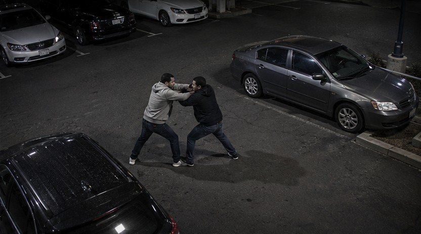 Illustration: two people fighting in a parking lot