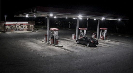 Fuel station forecourt at night