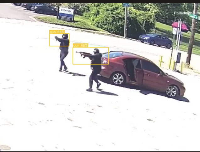 Real screenshot from the Vengeea dashboard: two armed individuals identified at a gas station, bounding boxes and confidence scores overlaid